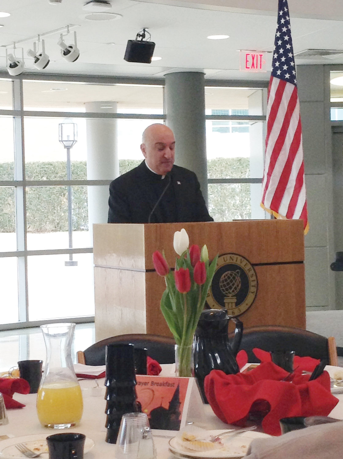 Father Robert Marciano, KHS, a member of Bryant’s Catholic Ministry, as well as pastor of St. Kevin Church and administrator of St. Benedict Church, both in Warwick, and president of Bishop Hendricken High School, delivers the keynote address during the event.